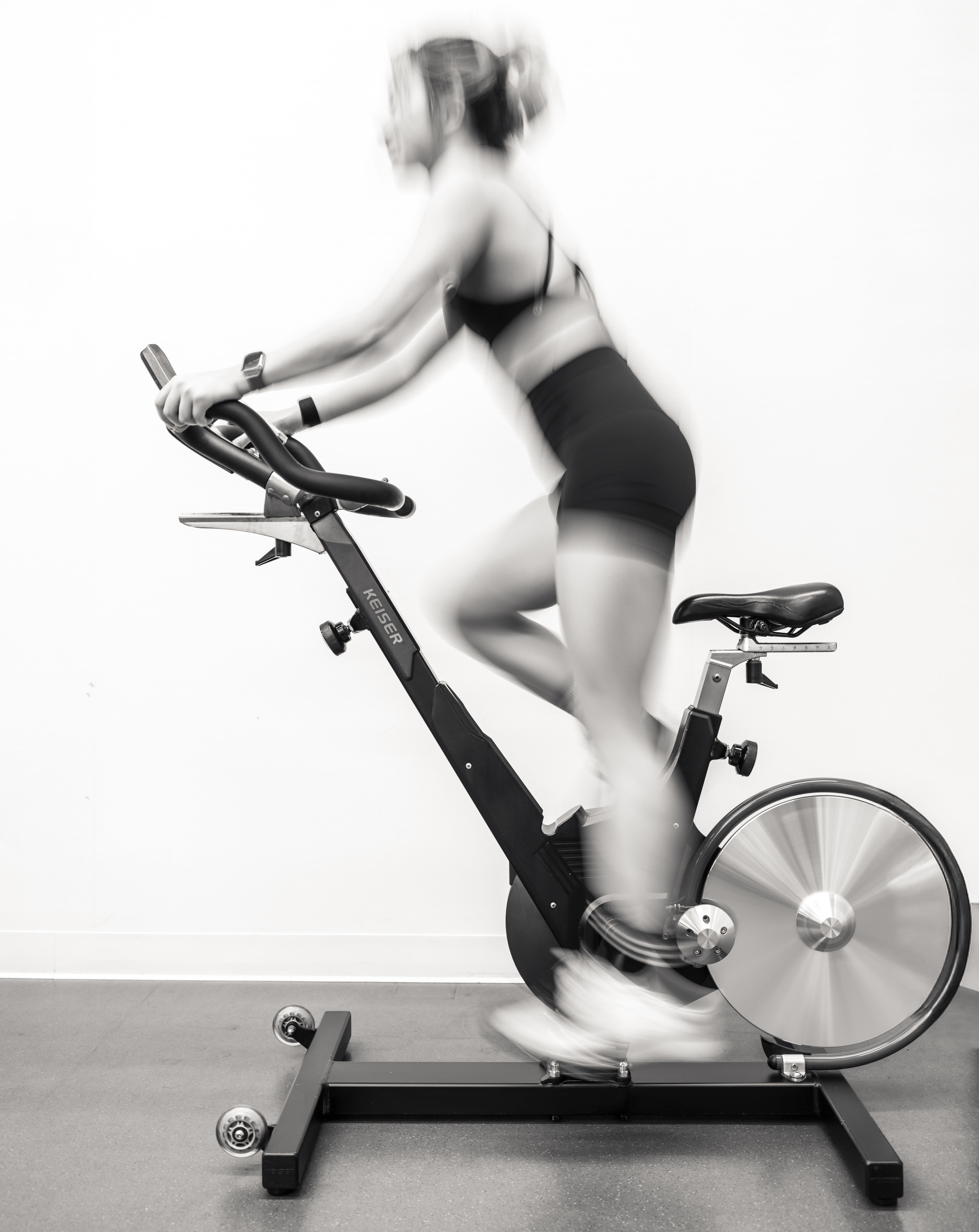 Elaine He standing with a bicycle in cycling gear